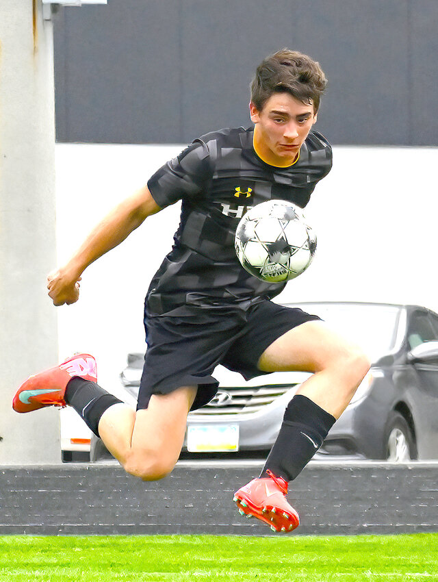 Central Lee sophomore Mason Sanders sends his first goal into the net Monday night in the Hawks' 3-0 shutout of Highland at home.