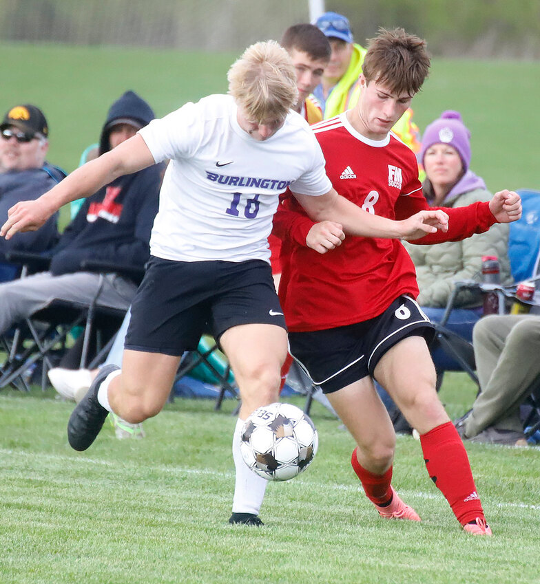 Fort Madison's Connor Horn (8) battles with a Burlington forward during Monday night's 4-0 loss to the Grayhounds at Baxter Sports Complex. BHS scored all four of their goals in the second half.