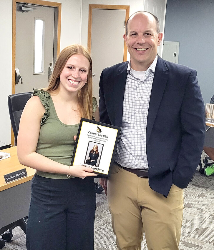 Central Lee Superintendent Dr. Andy Crozier presents senior Lauren Sanders with a plaque in honor of her final day as the student senior representative on the Central Lee Board of Directors. Sanders is interested in pursuing a career in finance.