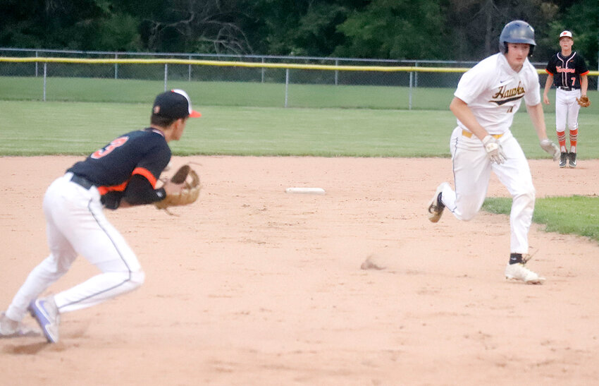 Central Lee's Brayden Wyrick races to third trying to avoid Van Buren County's Izaak Loeffler in the process. Loeffler had just fielded a grounder and chased Wyrick down, tagging him out.