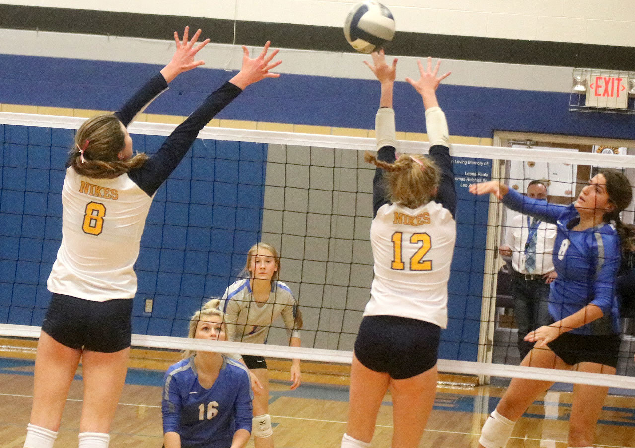 Holy Trinity senior Claire Pothitakis attacks from the left side of the Crusader rotation in Monday's 5-set loss to Burlington Notre Dame. Photo by Chuck Vanden berg/PCC