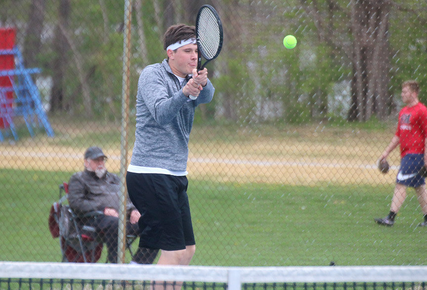 Jason Thurman returns a shot in a match earlier this season. Thurman and brother Vasin Thurman won the SEC doubles tourney Thursday in Fort Madison. Photo by Chuck  Vandenberg/PCC