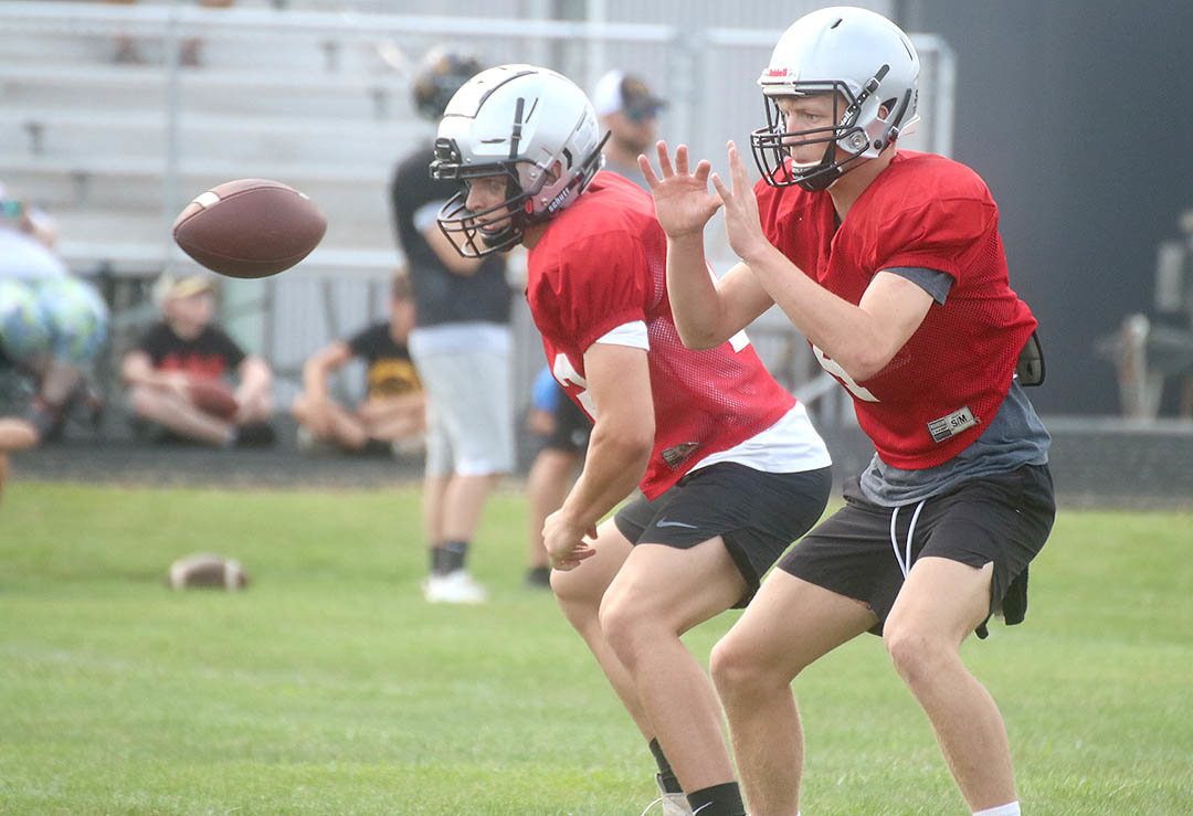 Fort Madison quarterback Landes Williams takes a snap Thursday during the Hounds offensive session in drills at Central Lee. Photo by Chuck Vandenberg/PCC