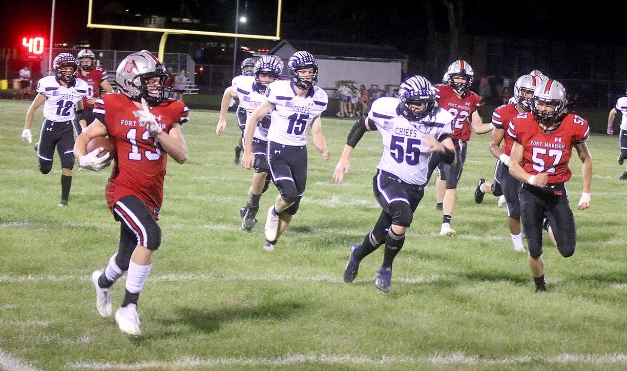 Fort Madison senior Tate Johnson rumbles down the home sideline for an 81 yard kick-off return  touchdown Friday night in Fort Madison as the Bloodhounds downed Keokuk 43-0. Photo by Chuck Vandenberg/PCC