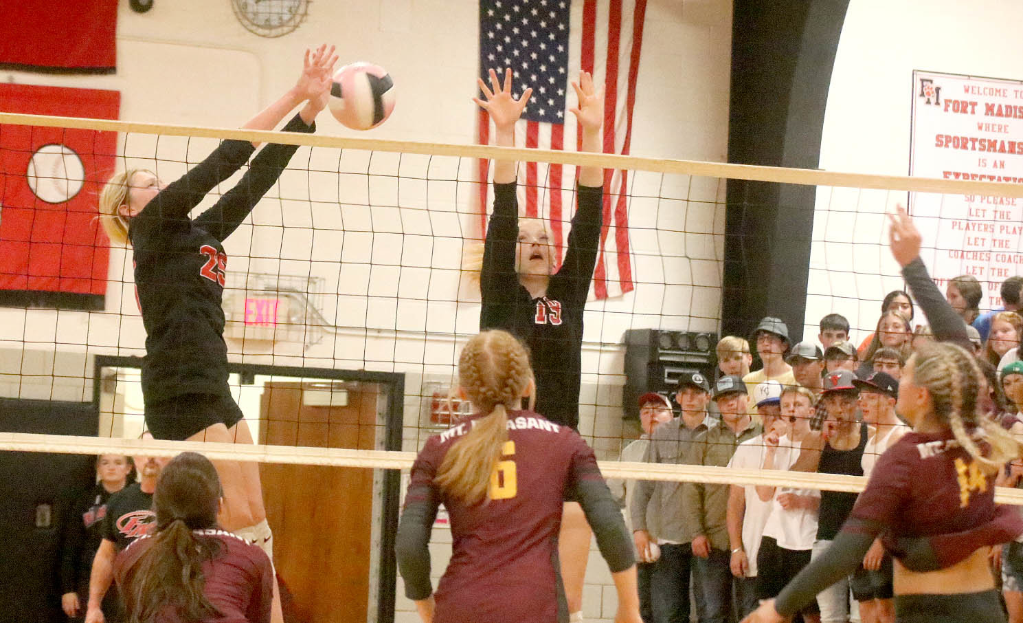 Fort Madison's Taylor Johnson goes high at the net with Eve Ruble to block at Panther attack. Photo by Chuck Vandenberg/PCC