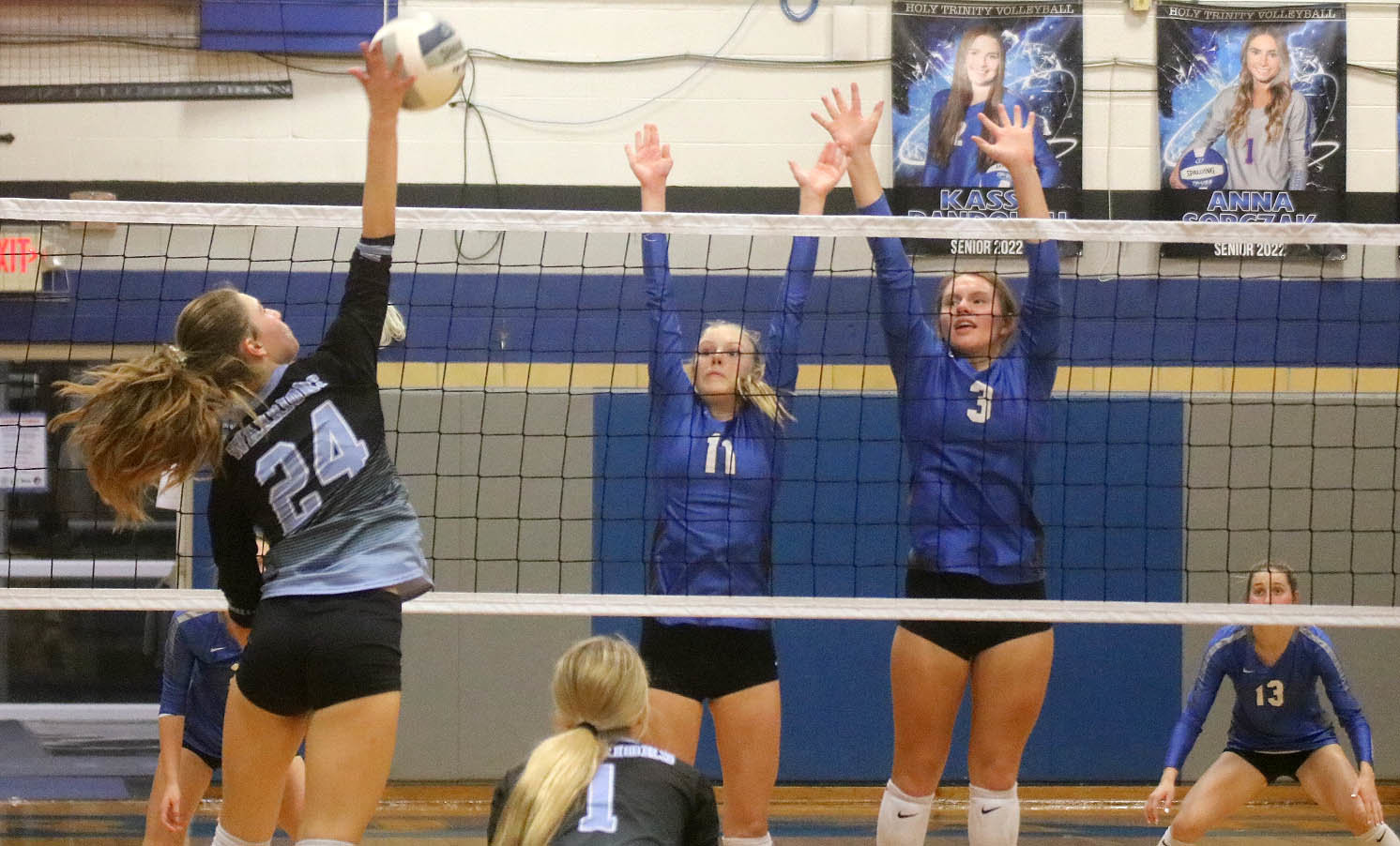 Natalie Randolph (11) and Kayla Box (3) put up a block on WACO's Marie Farmer in the third set Thursday night. The Crusaders won 4-1 to move to 18-4 on the year. Photo by Chuck Vandenberg/PCC