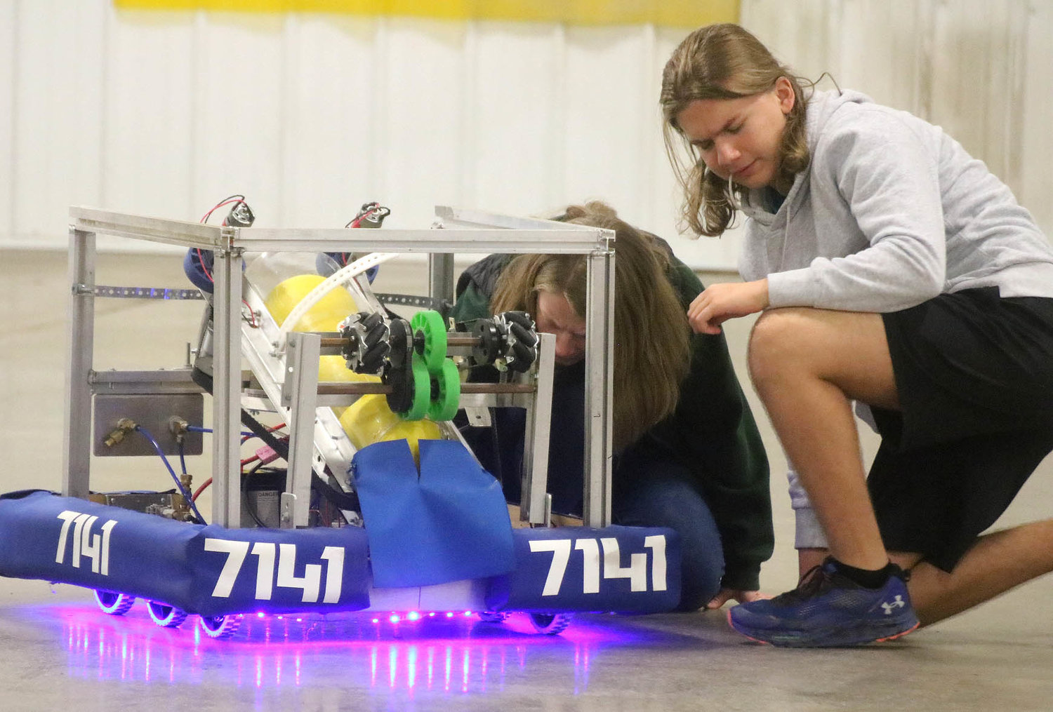 Students with the Lee County Robotics team look over a "Big Bot" that was built last year for a basketball shooting game created by the team at Fort Madison High School. Photo by Chuck Vandenberg/PCC