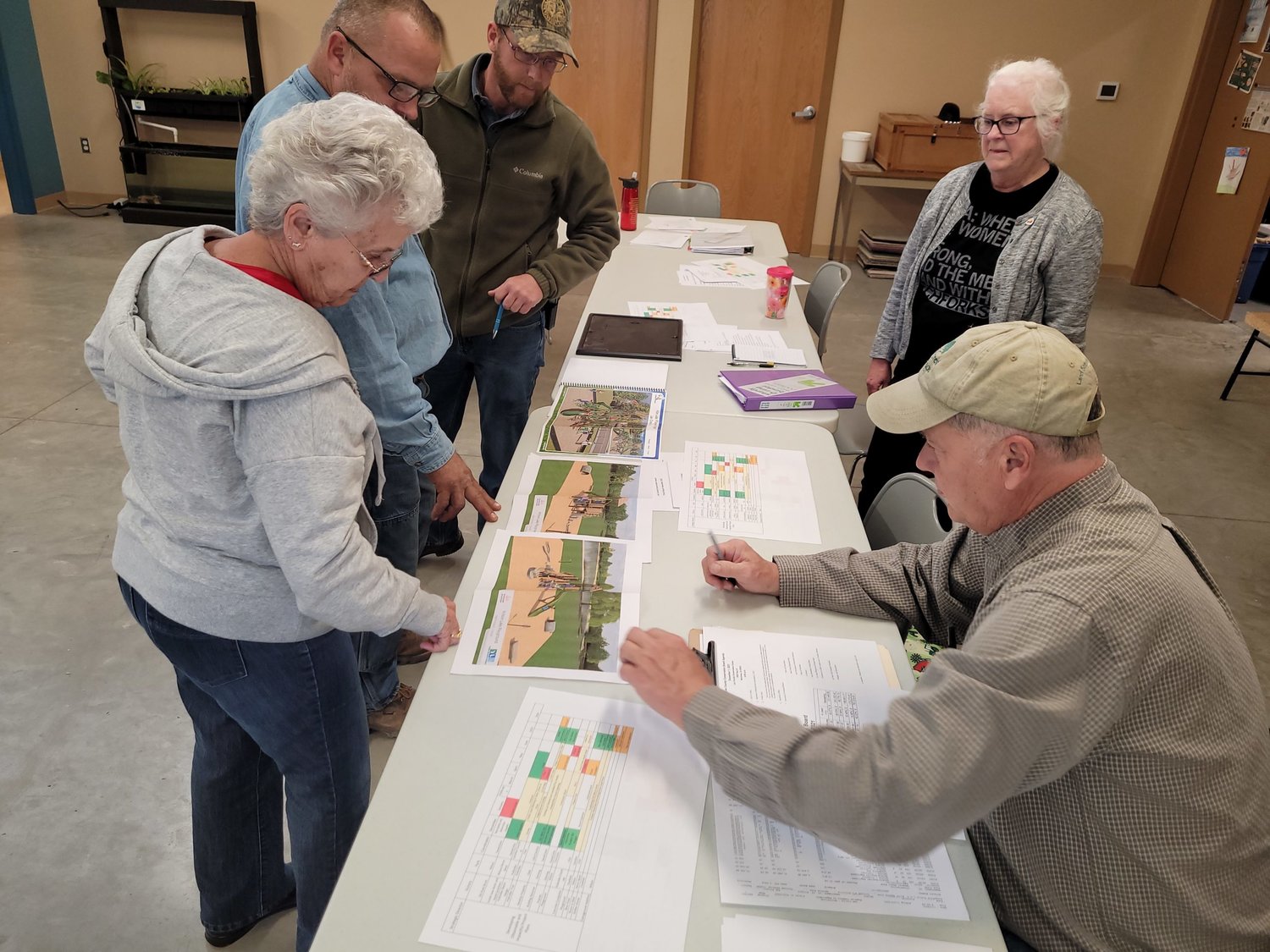 Members of the Lee County Conservation Board look over plans for a new playground layout for Wilson Lake that is set to go up next spring. The playground will cost about $82,000 and will be paid for out of the Conservation Board’s trust fund which is replenished with park revenue.