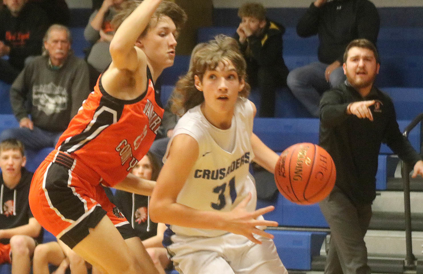 Holy Trinity Catholic freshman Luke Hellige drives in the first quarter of the Crusaders' 44-43 win over Van Buren Tuesday night. Photo by Chuck Vandenberg/PCC
