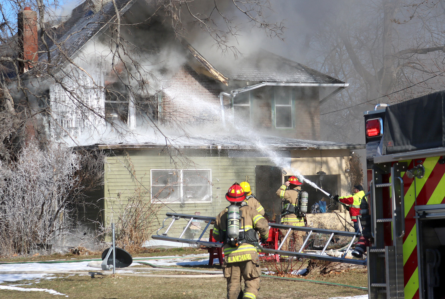 Fort Madison firefighters put water in the second floor window of a home at 1635 Avenue L Wednesday afternoon. The fire started in a chimney from a wood burning stove on the first floor living room. No one was injured in the fire. Photo by Chuck Vandenberg/PCC