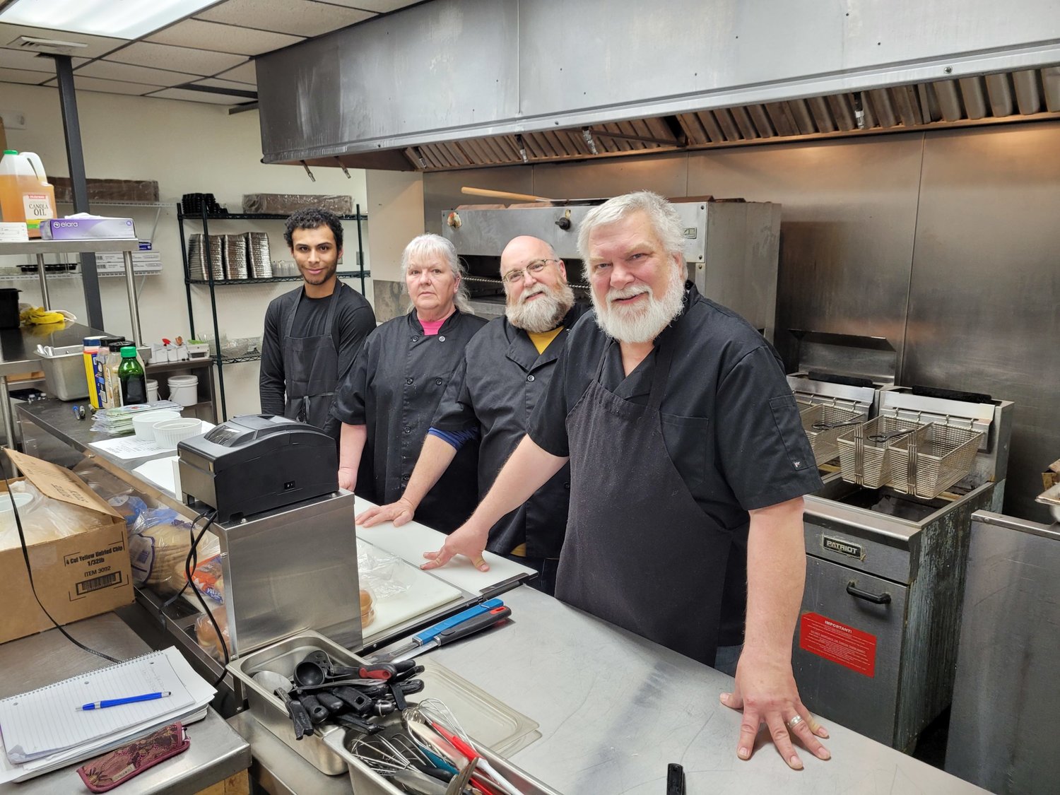 Fort Madison's Dave Taylor and his crew were hard at it in the kitchen of River Rocks Saturday during the group's soft opening of a new food menu at the bar. Photo by Chuck Vandenberg/PCC