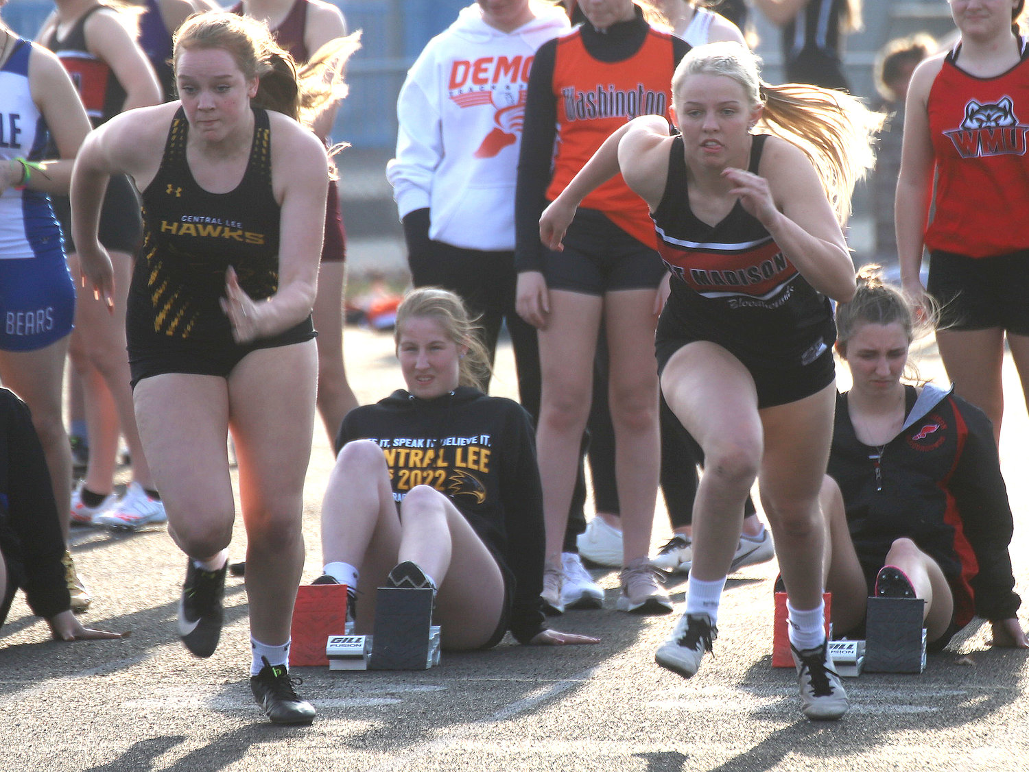 From left Central Lee's Allison Kerr and Fort Madison's Emily Steffensmeier take off in the 2nd heat of the 100-meter dash. Steffensmeier would win the heat at 14.60 and finish 11th in the event at the Timm Lamb Pen City Relays in Fort Madison Tuesday night. Photo by Chuck Vandenberg/PCC