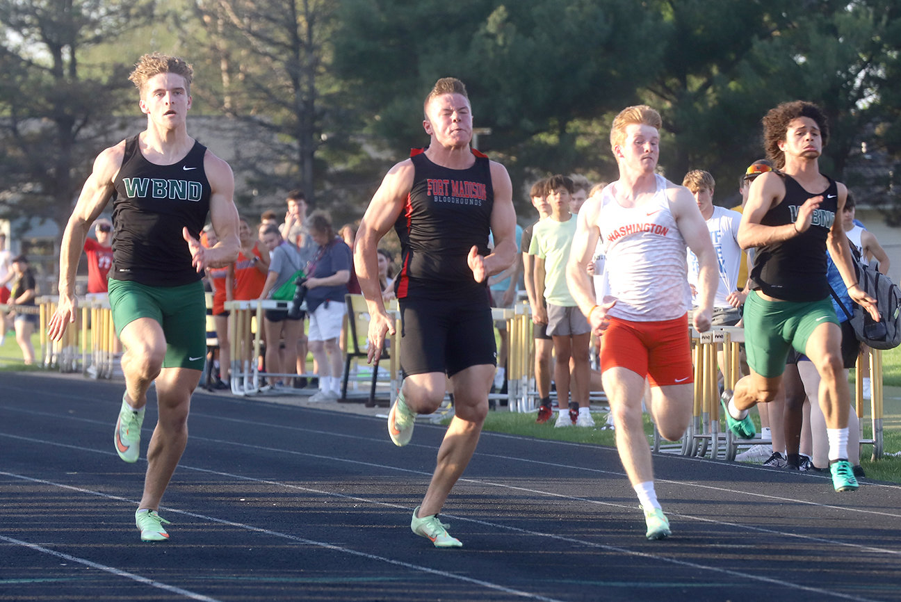 Fort Madison's Tate Johnson, 2nd from left, edges West Burlington's Jack Riley in the open 100 Thursday in Mt. Pleasant. The win pushed Johnson into the state meet Thursday in Des Moines. Photo by Chuck Vandenberg/PCC