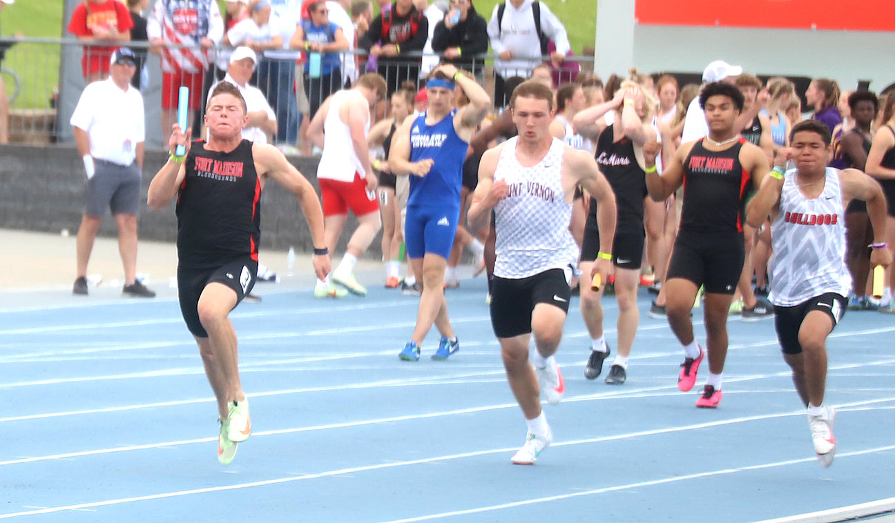 Fort Madison's Hayden Segoviano hands the baton to Tate Johnson on the final leg of the 4x100 preliminaries Friday evening in Des Moines. Photo by Chuck Vandenberg/PCC