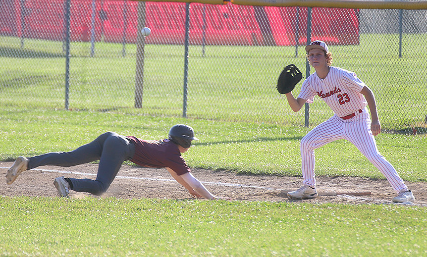 Reiburn Turnbull takes pick-off attempt from Landes Williams in the first game of the Hounds' doubleheader Thursday. The Hounds won 5-3 and 3-1 to earn the sweep over Mt. Pleasant. Photo by Chuck Vandenberg/PCC