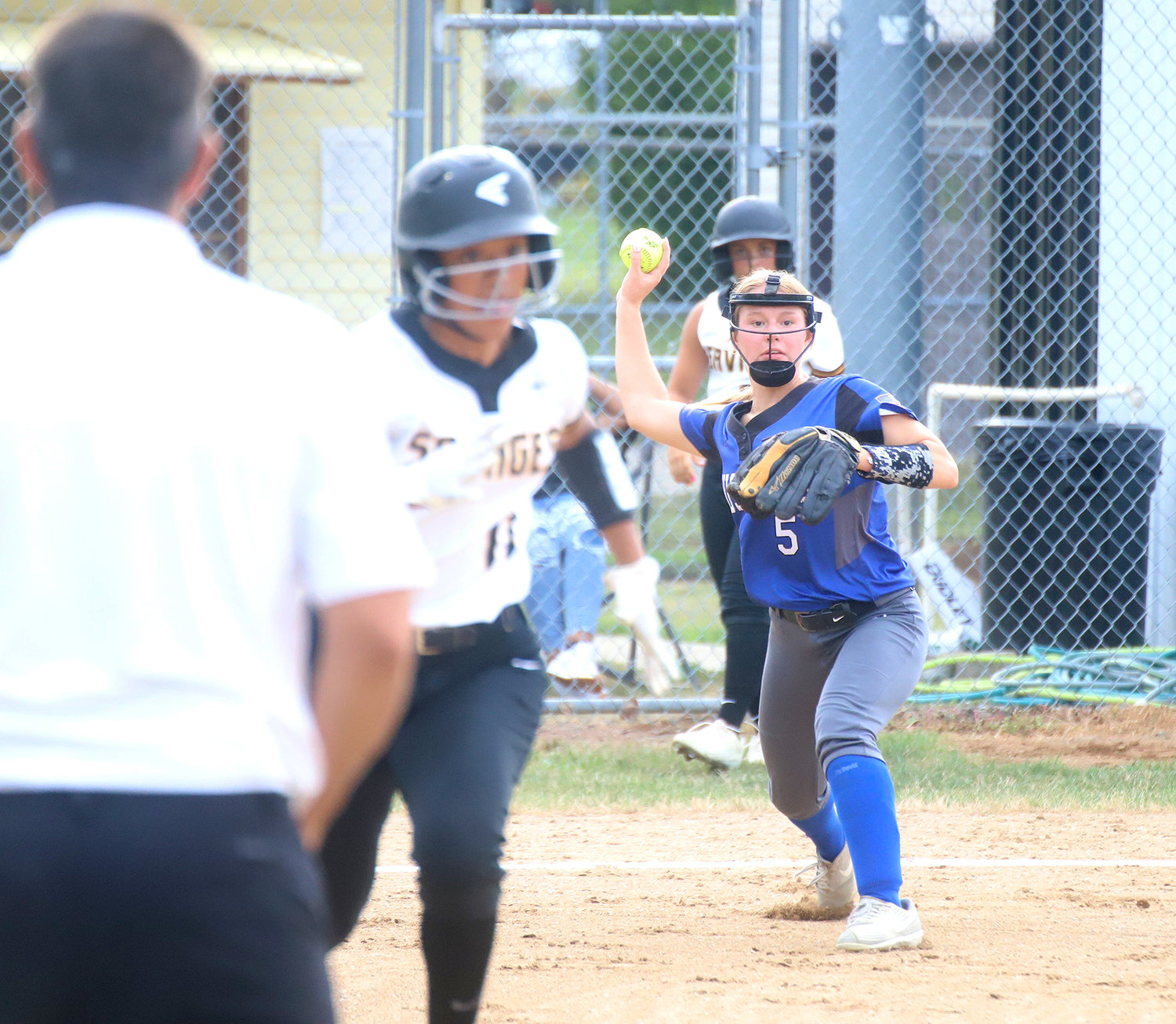 HTC's Kayla Box (5) comes up throwing after Sigourney's Amiya Smallwood (11) tried to bunt her way on in the second inning.