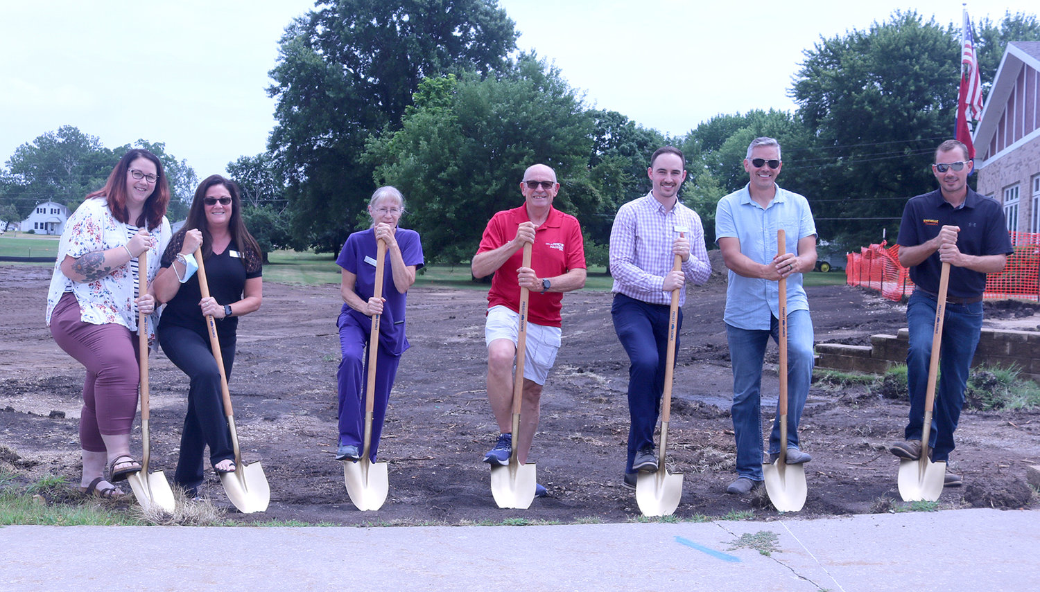 Dignitaries including Fort Madison Mayor Matt Mohrfeld, center, and The Madison staff, along with owner Mark Holtkamp and Construction Manager Mark Schickedanz break ground at The Madison's expansion project in Fort Madison Wednesday afternoon.