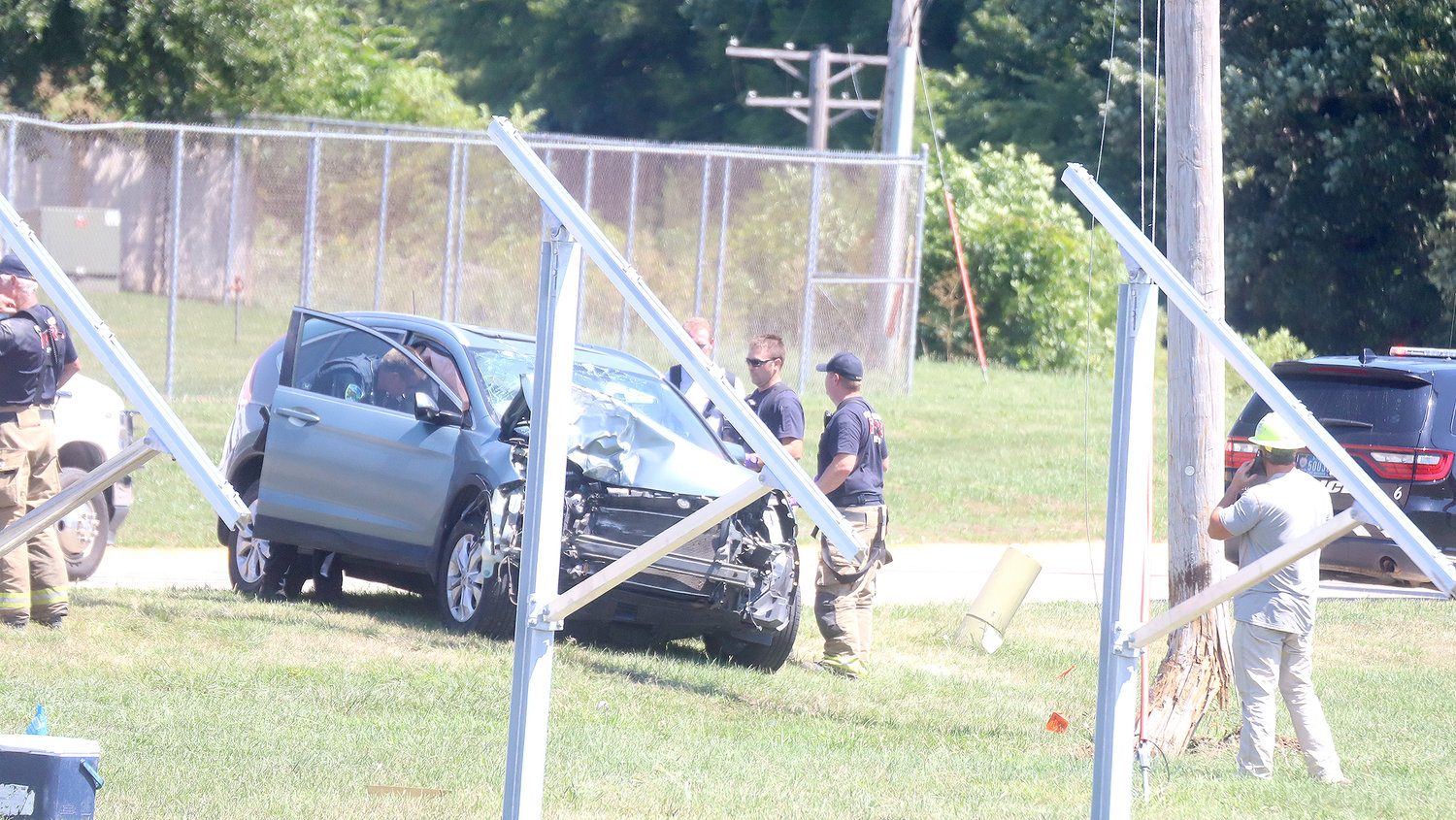 First responders work at the scene of a one-vehicle accident near Willow Patch Access just off Country Club Lane Tuesday morning. The vehicle shown struck the utility pole to the right, sending one person to the hospital by ambulance.