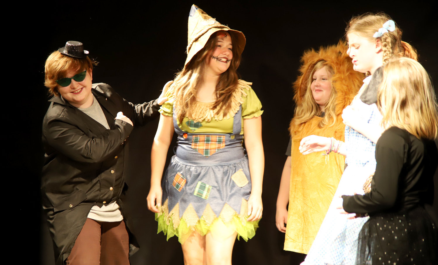 Oscar Bauswell helps out Scarecrow, the Cowardly Lion, the Tin Woodsman, Dorothy, and Toto in The Wizard of Oz Monday night at the OFP's dress rehearsal for the summer youth production. The shows kick off July 29 in Fort Madison.