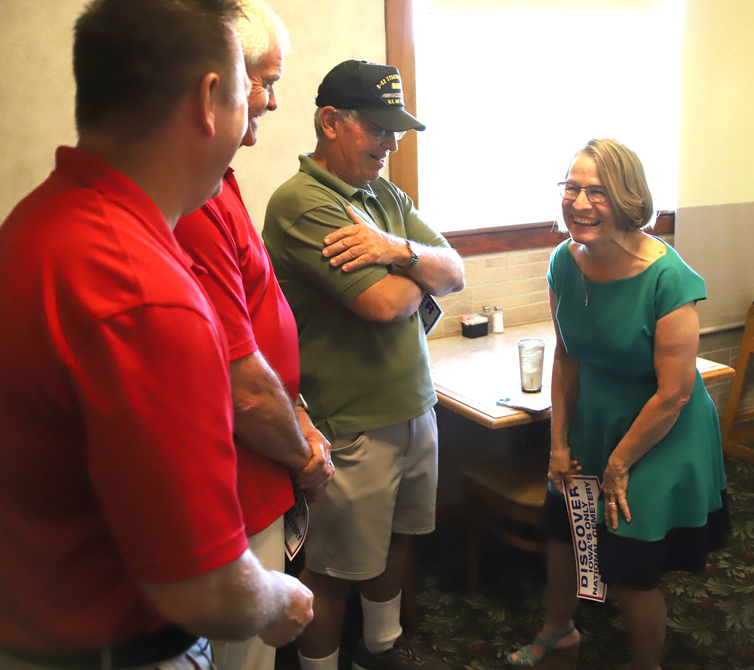 Congresswoman Mariannette Miller-Meeks talks with Bill Smith of Keokuk, State Rep. Martin Graber (R-Fort Madison), and State Sen. Jeff Reichman (R-Montrose) during a meet-and-greet Wednesday at Fort Colony restaurant.