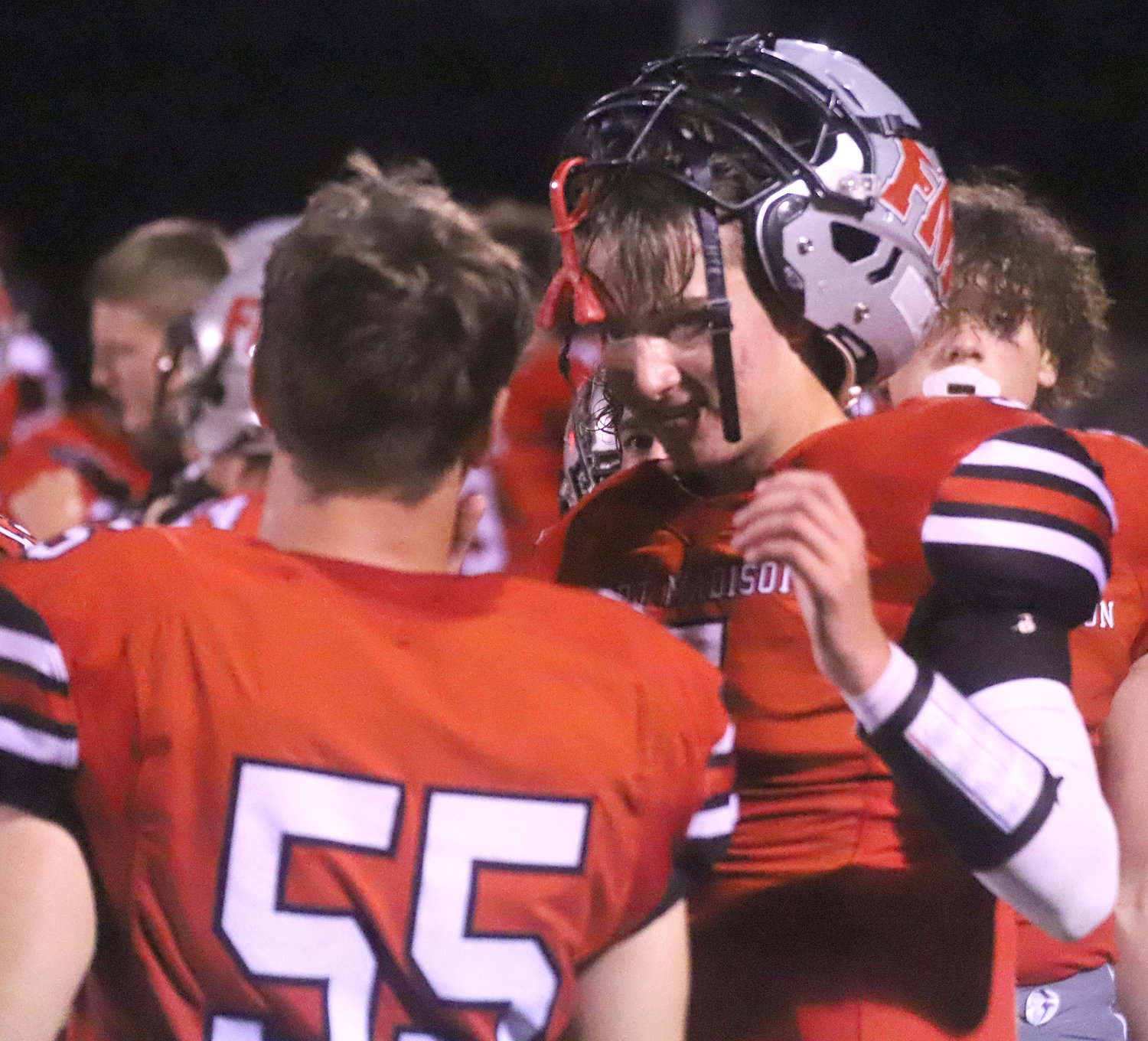 Quarterback Aidan Boyer talks with Tanner Settles during the final minutes of the first half of Friday night's 37-7 win over Washington in Fort Madison.