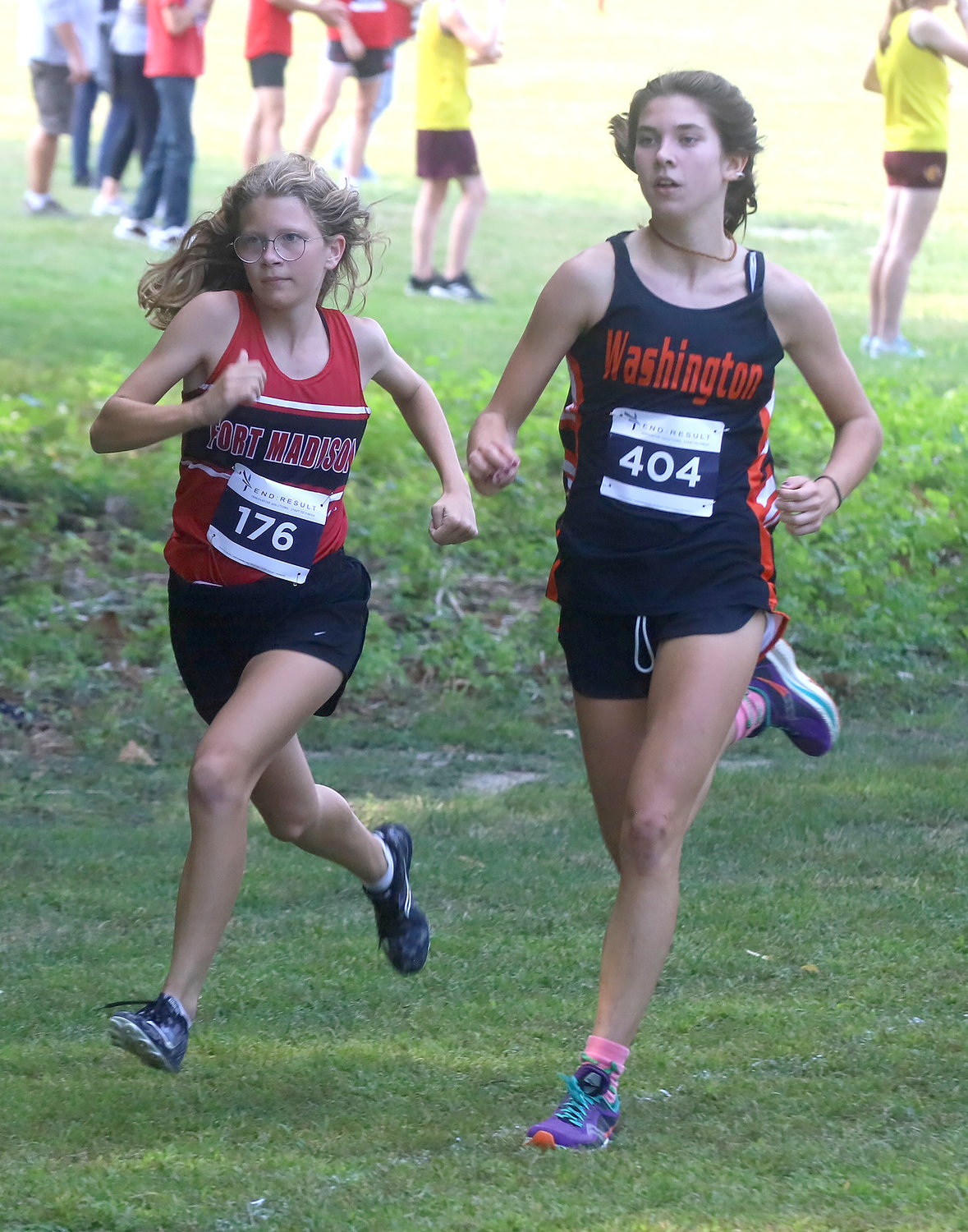 Fort Madison freshman Avery Rump, left, battles with Washington freshman Iris Dahl in the early going of the Timm Lamb Cross Country Invitational Thursday afternoon at Rodeo Park in Fort Madison. The two runners would finish 1st and 2nd, respectively.