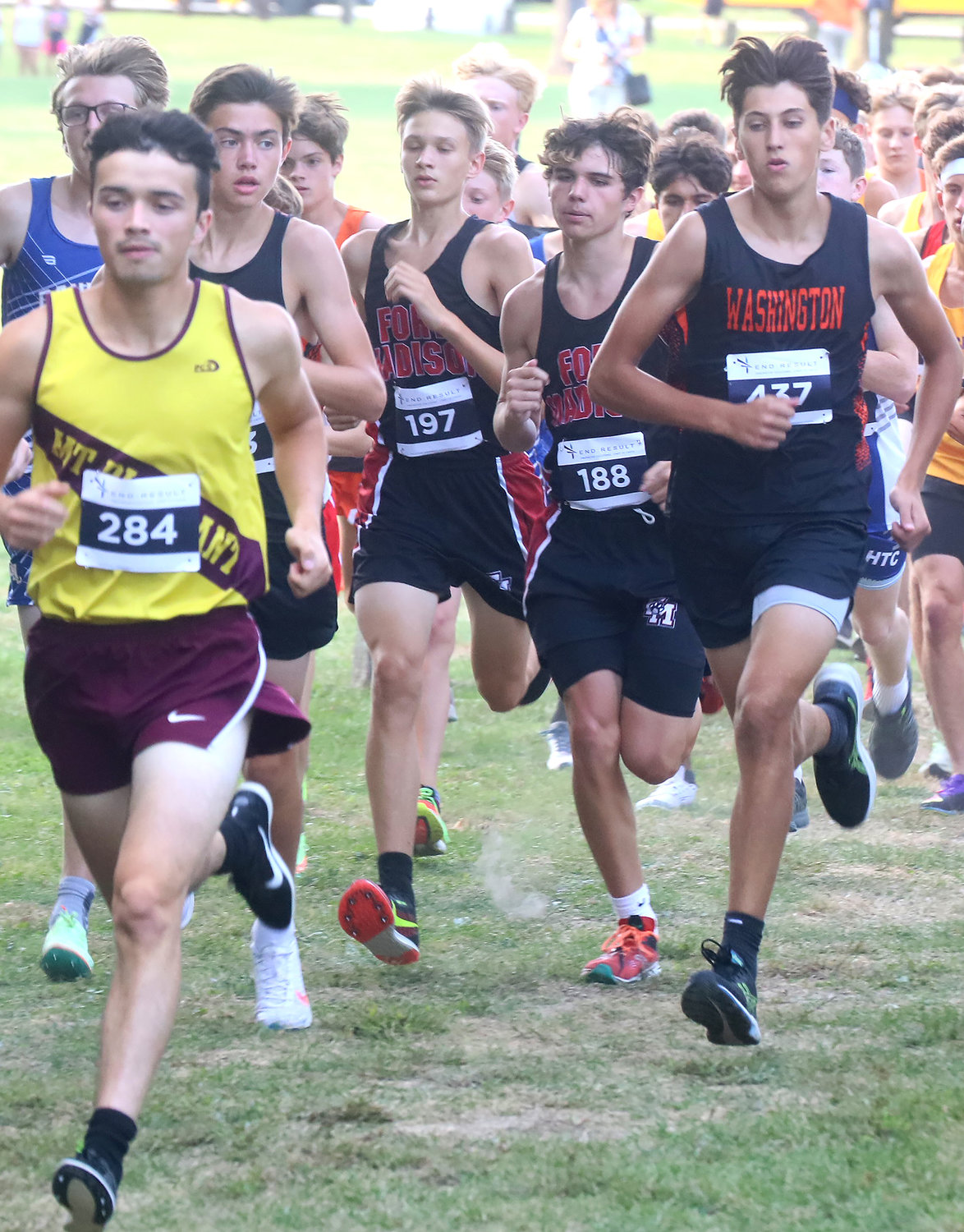 From left to right, in the pack for Fort Madison, Riley Tripp (197) and Mason McLey (188) jockey for position just inside the fence at the Timm Lamb Cross Country Invitational Thursday in Fort Madison.