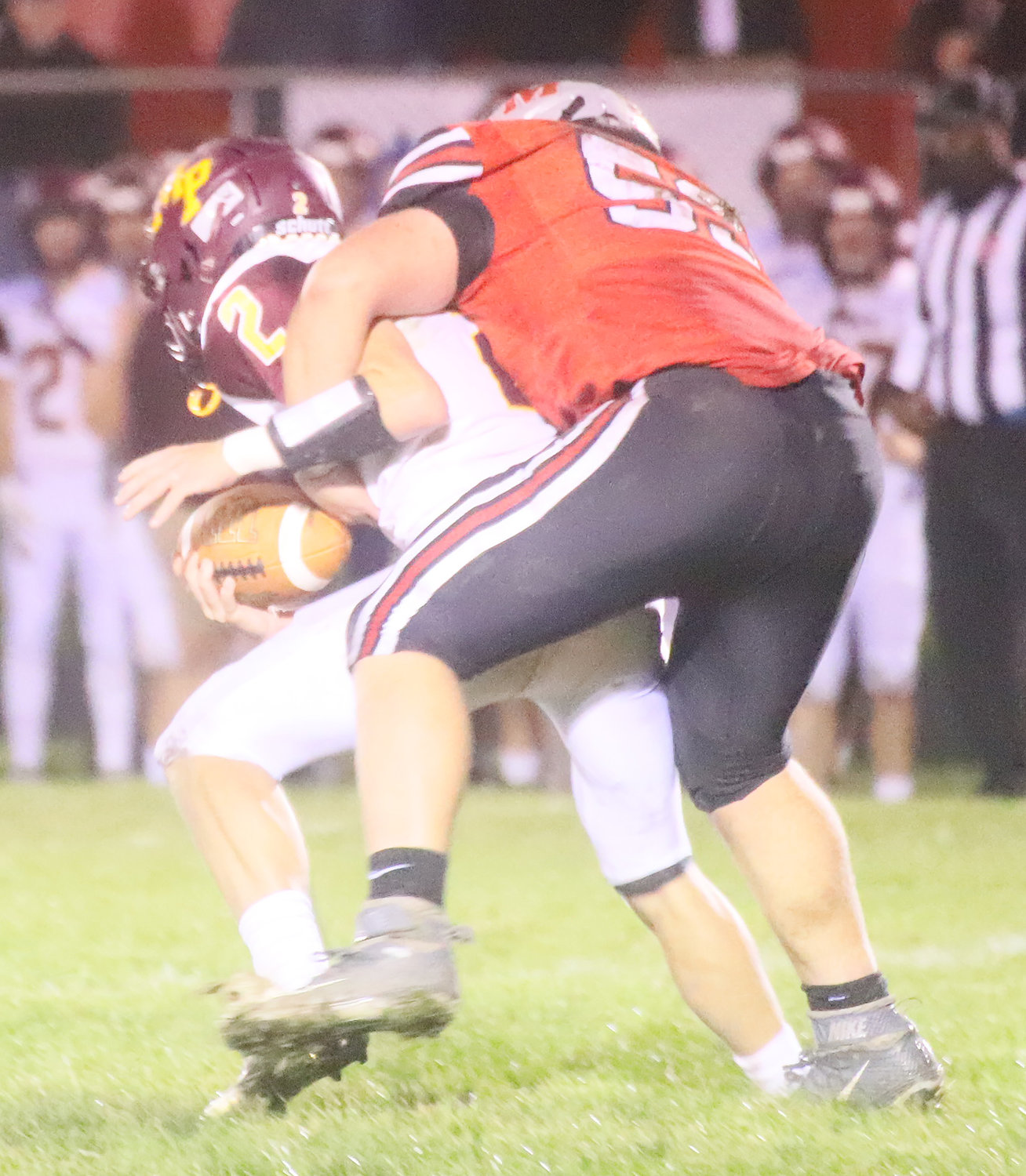 The Hounds' Daniel Sokolik is in the backfield again Friday night as he gets a sack on Mt. Pleasant's Jacob Richtman in the third quarter Friday night in Fort Madison.