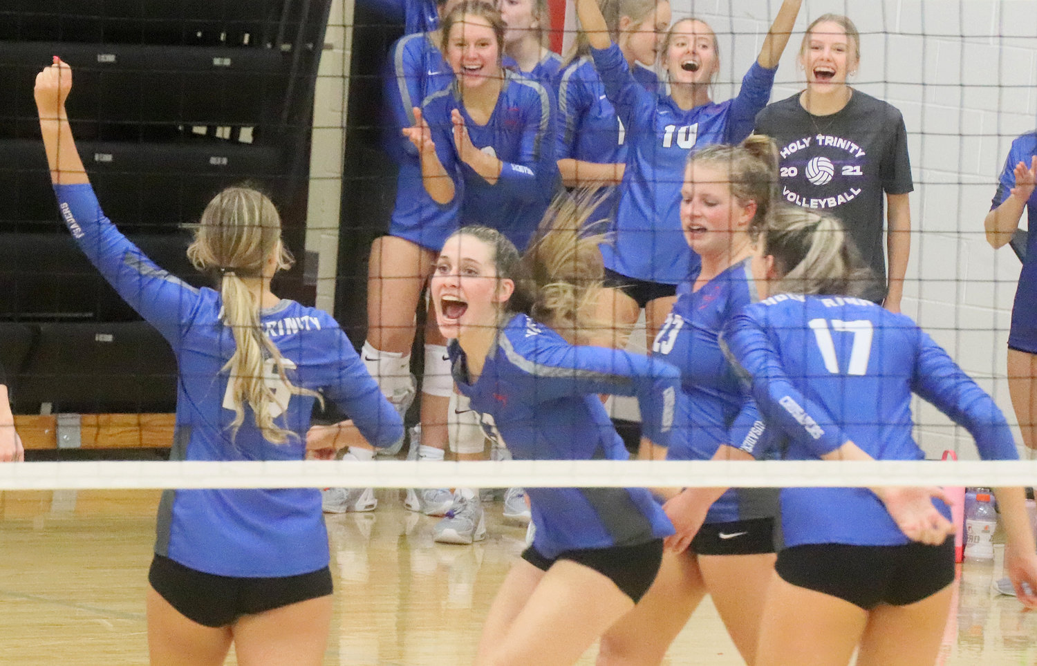 The Crusaders celebrate a tie breaker win in the third game against WACO to advance to the semifinals Saturday night in Burlington.