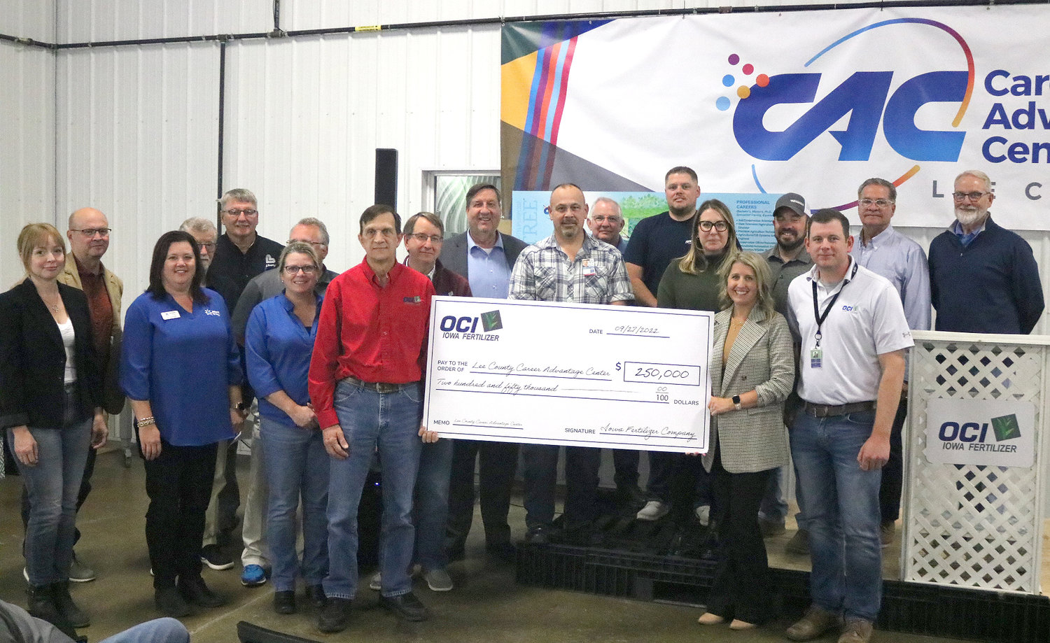 Members of the LCEDG Board, local officials and representatives of OCI Iowa Fertilizer pose with a check for $250,000 to the Lee County Career Advancement Center Tuesday