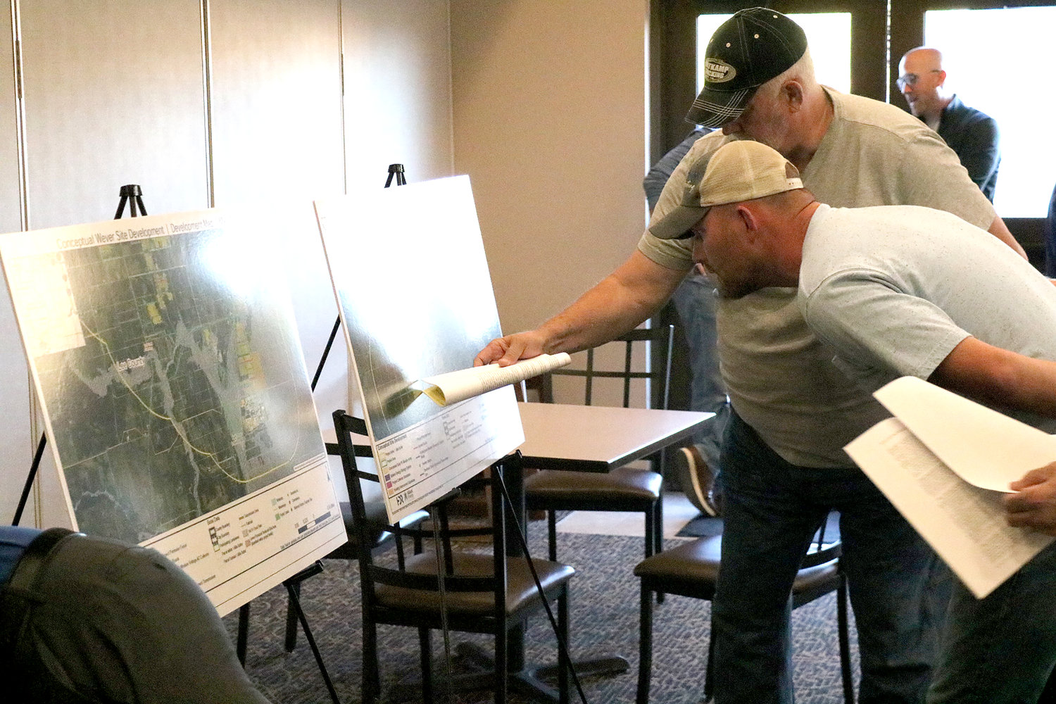 Concerned property owners look over a map of a proposed Alliant Energy Solar Field near Wever at a meeting Tuesday night at Cobblestone Inn & Suites in Fort Madison.