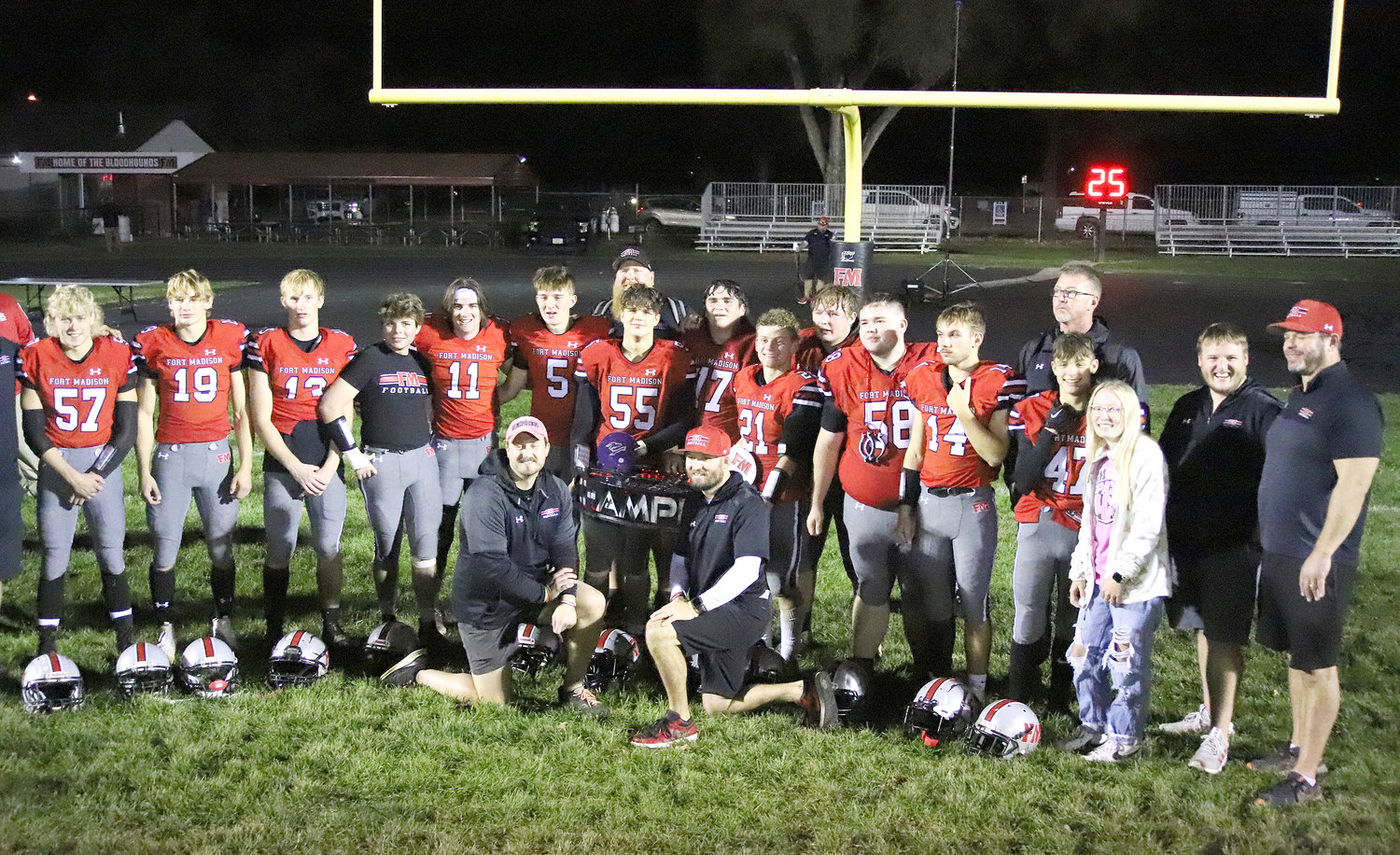 The Bloodhounds pose with the Burlington/Fort Madison Champs trophy after Fort Madison knocked off the Grayhounds 28-24 Friday in Fort Madison.