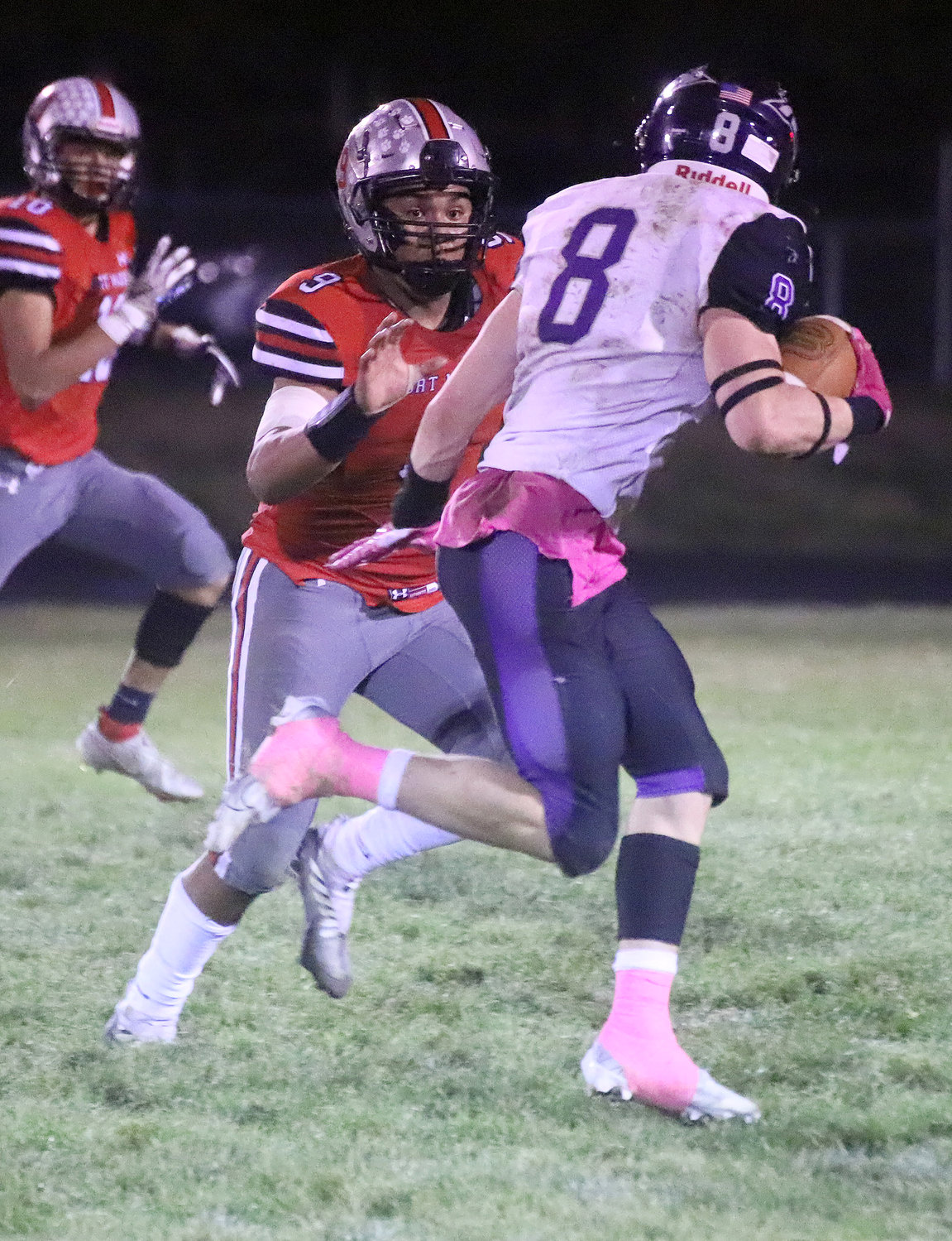 Hayden Segoviano closes in on Caden Schisel (8) in the third quarter of Friday night's 28-24 Bloodhound win in Fort Madison.