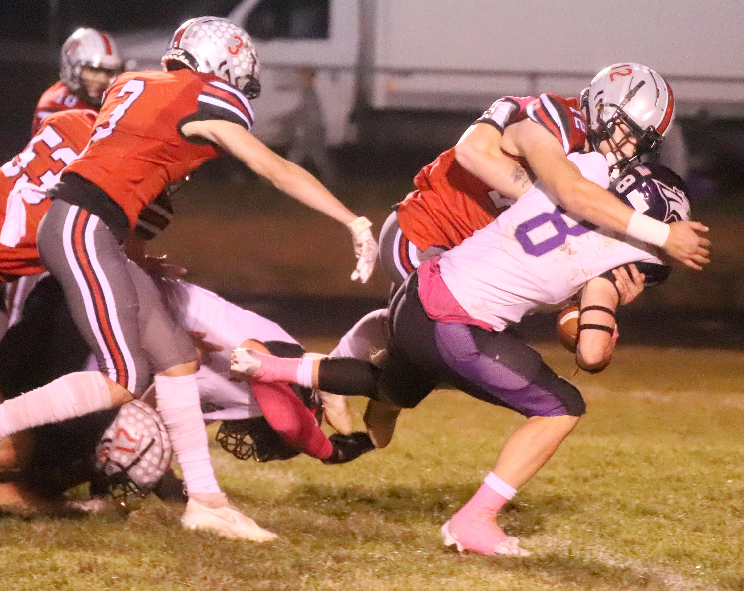 Marcus Guzman wraps up Burlington's Caden Schisel after a gain in the first half of the Bloodhounds' win Friday.