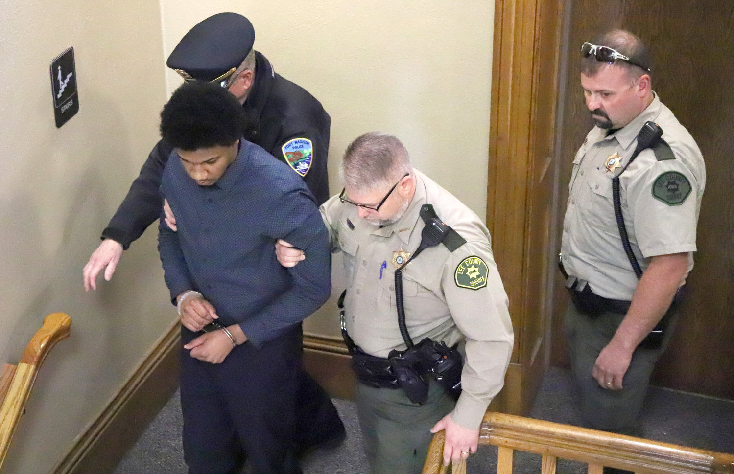 Dimari Meredith is escorted from North Lee County Courthouse by Lee County Sheriff Stacy Weber, Fort Madison Police Chief Mark Rohloff, and Lee County Jail Administrator John Canida Friday afternoon.