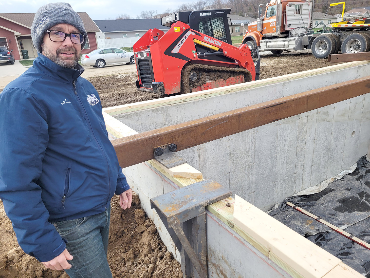 Mike Norris, President of Homes for Iowa, stands near the foundation of a home where one of the program's newest projects is being set this week. Fort Madison has placed two of the offender-built homes.