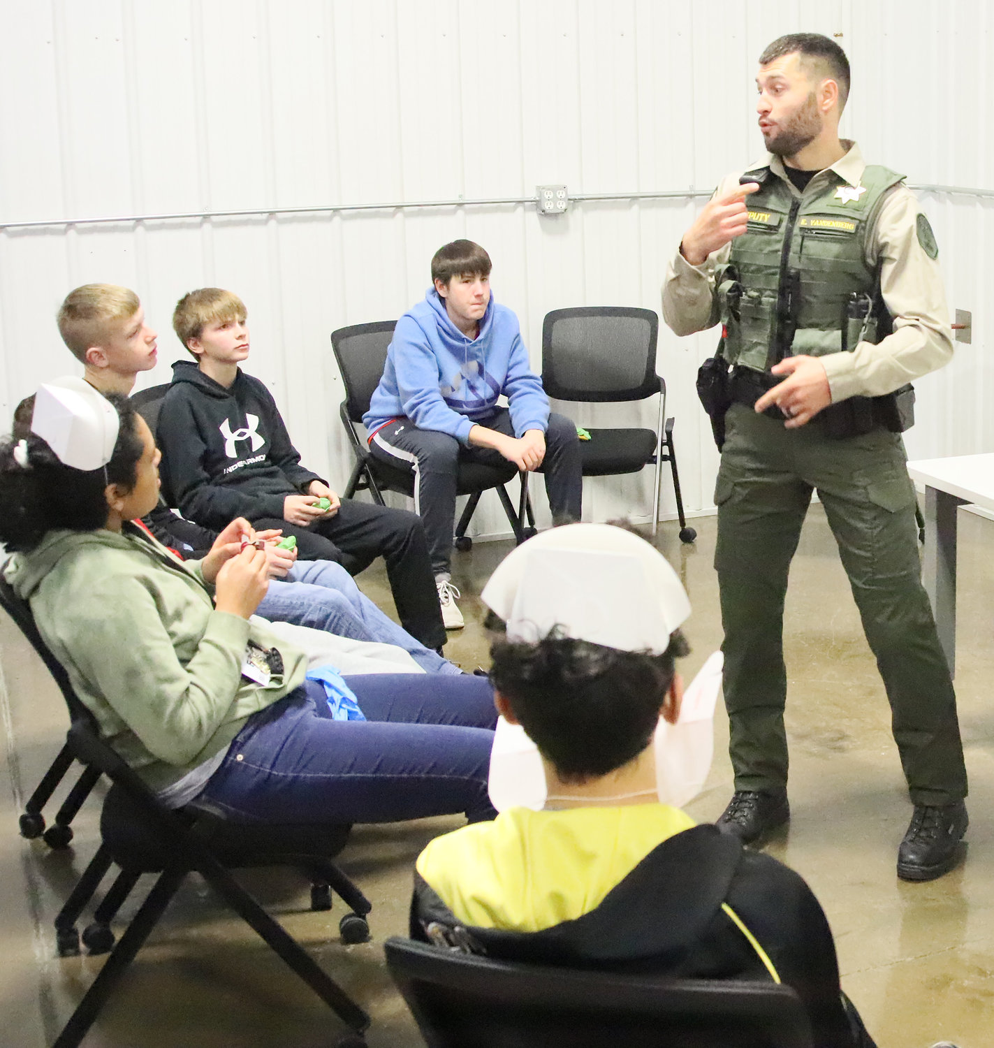 Lee County Sheriff's Deputy Elliott Vandenberg talks with students about the day-to-day operations of the sheriff's department.
