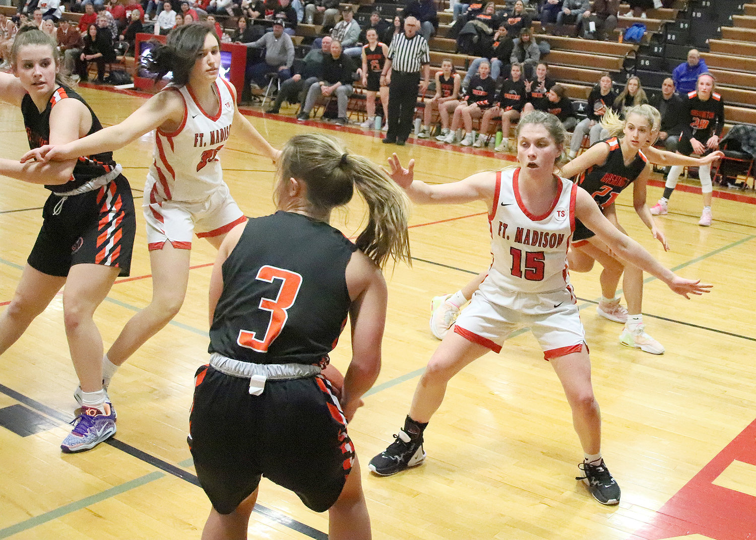 The Lady Hounds Irelynd Sargent (15) cuts off Washington's Makenna Conrad at the baseline in the 4th quarter of Tuesday's game in Fort Madison