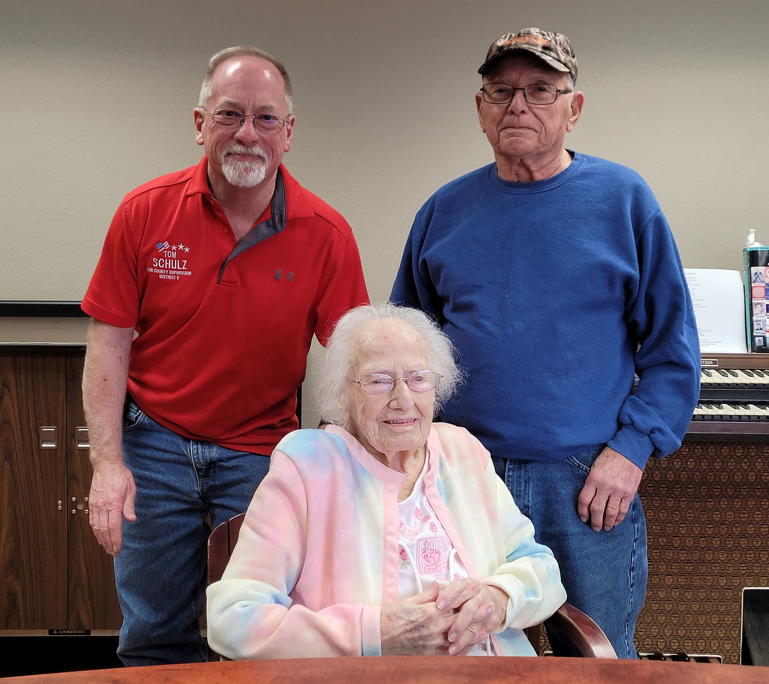 Mildred "Millie" Schulz turns 107 years old on Wednesday. She's joined here by her grandson Tom, upper left, and her son Jerry, upper right.