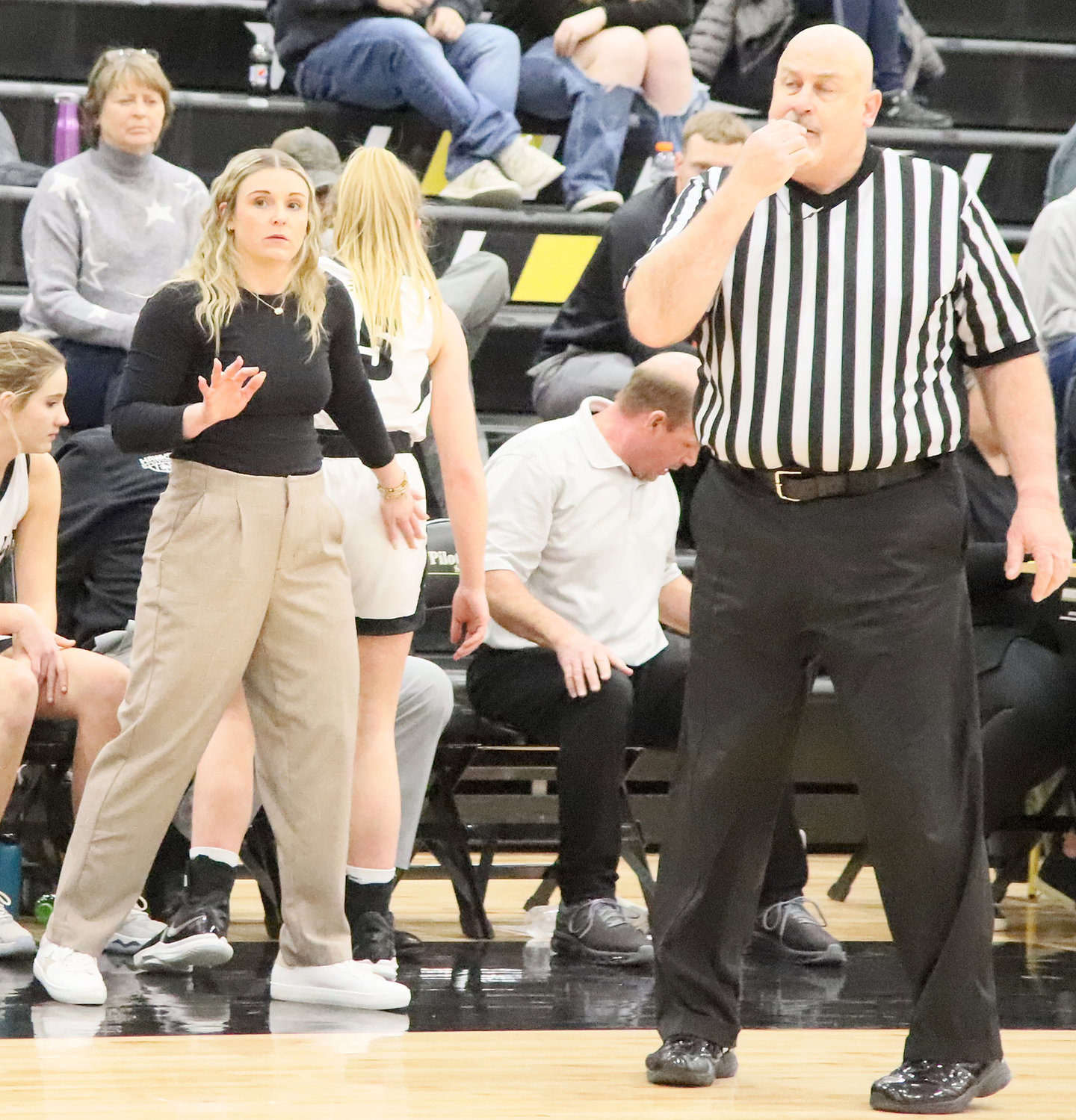 Central Lee Head Coach Taylor Hickey tries to get the Lady Hawks to calm down in the waning moments of overtime Tuesday night at Central Lee.