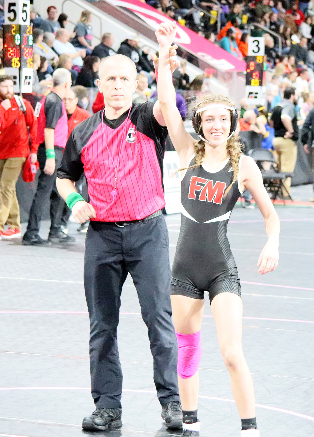 Kemper gets her hand raised after winning in her first ever state tournament wrestling match at the Xtreme Arena in Coralville.