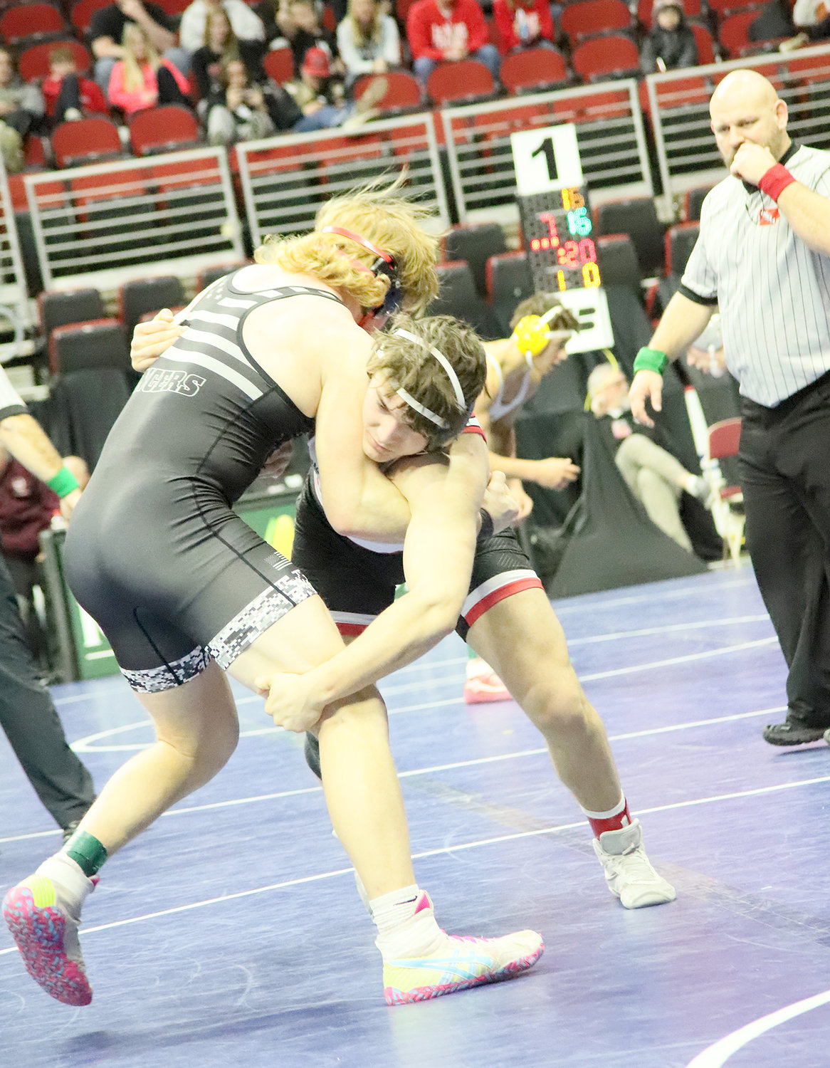 Thacher tries to get a leg for control in the early going of his match with North Scott's AJ Peterson Saturday at Wells-Fargo Arena in Des Moines.