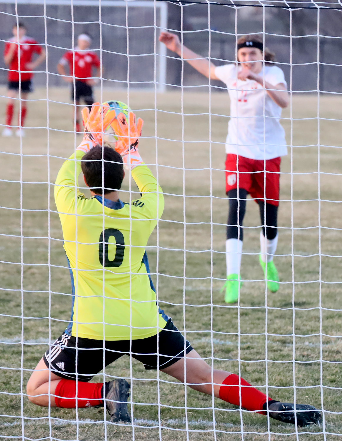 Fort Madison's Oliver Santiago gets a block on a penalty kick in a sudden victory penalty kick session Tuesday night at Baxter Sports Complex.
