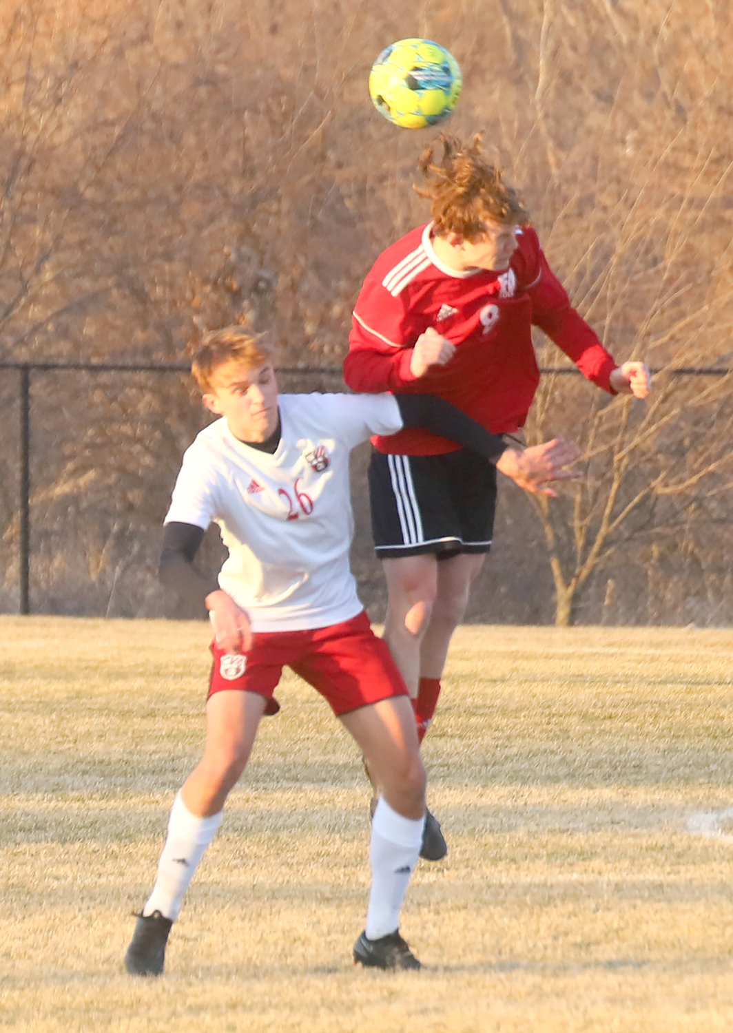 Defenseman Noah Swigart gets a header on a deep ball into the Hounds' side of the pitch Tuesday in Fort Madison.