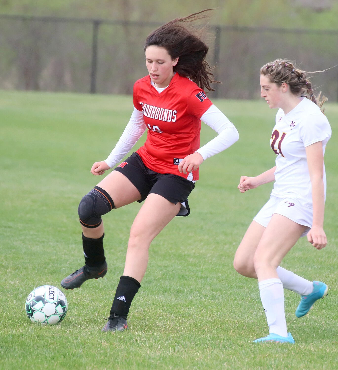 Hound freshman Halle Menke brings the ball through the midfield in the first half Thursday night.