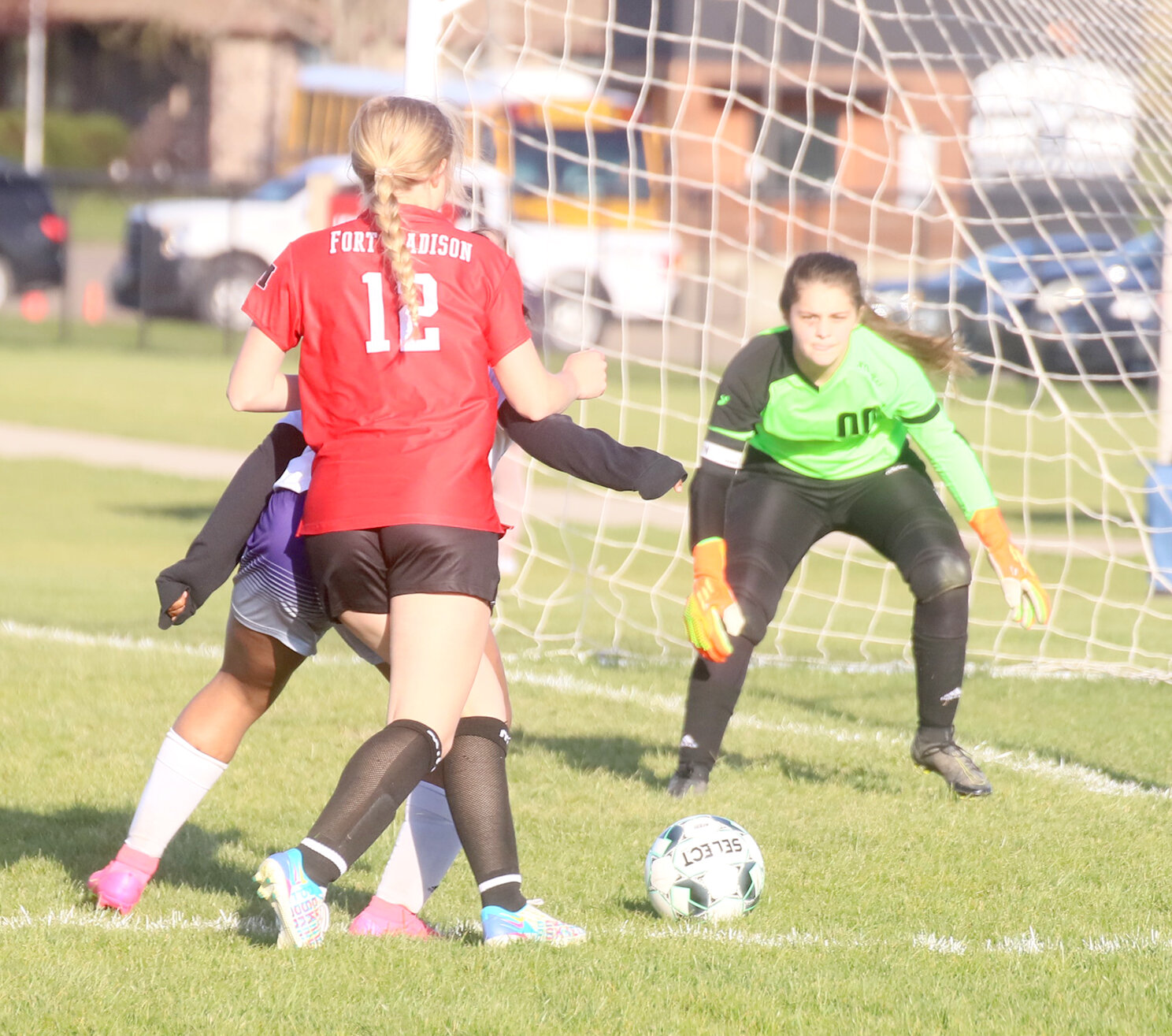 Laura Mehmert (12) tries to square up against the Keokuk keeper in the second half of the Hounds win over Keokuk Monday at Baxter Sports Complex in Fort Madison.