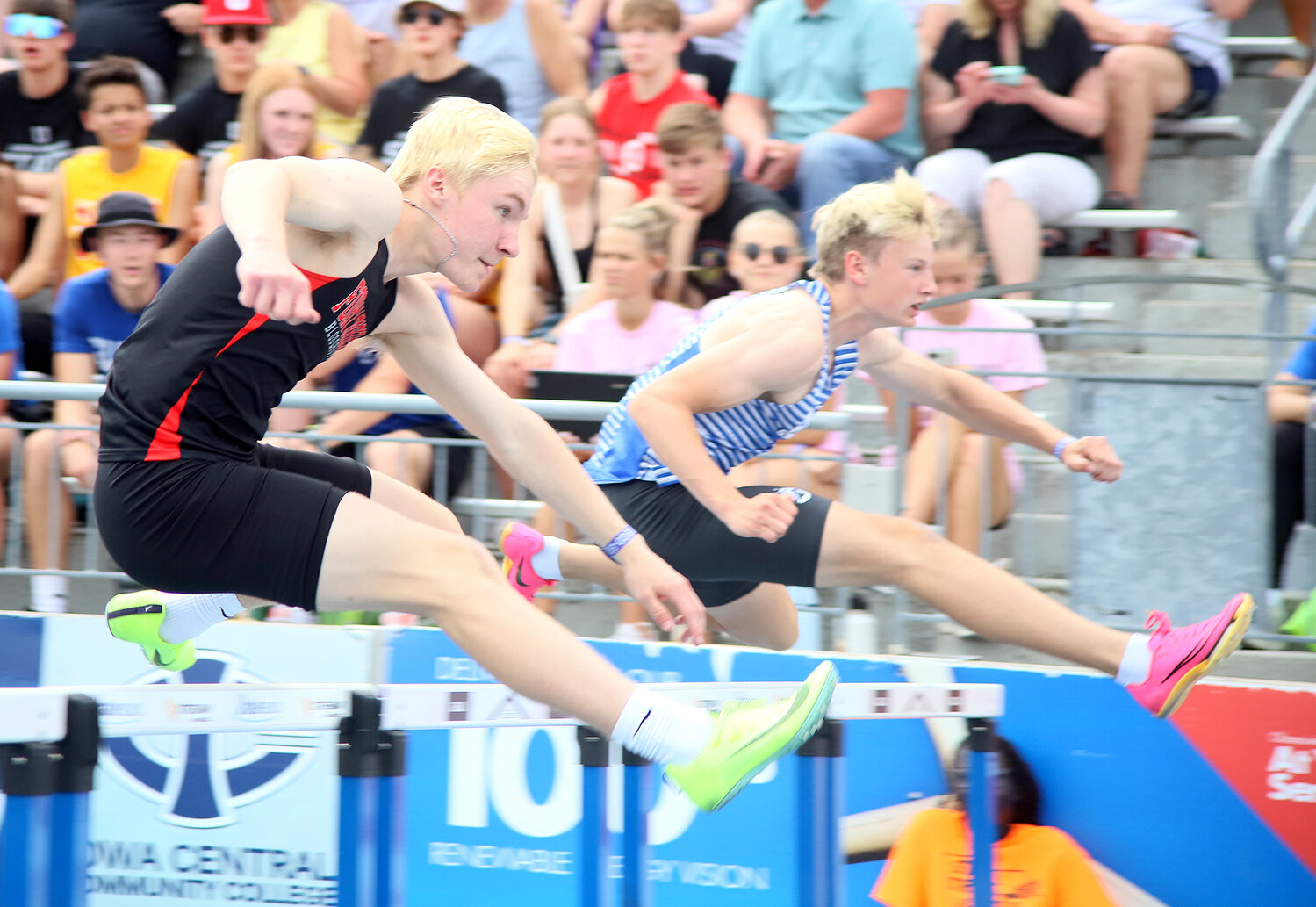 Fort Madison's Adam Sobczak keeps pace with Clear Creek Amana's Aren Schlemme on the first leg of the Class 3A 110-meter Shuttle Hurdle relay at Drake University in Des Moines. The Hounds would finish in 15th place, failing to qualify for Saturday's finals.