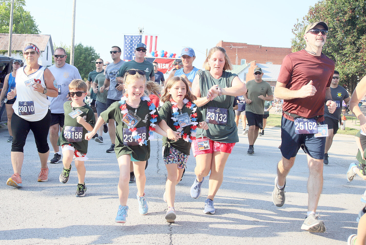 Runners take off from the starting line at the Tunnel to Towers 5K run Tuesday morning July 4th in Donnellson.
