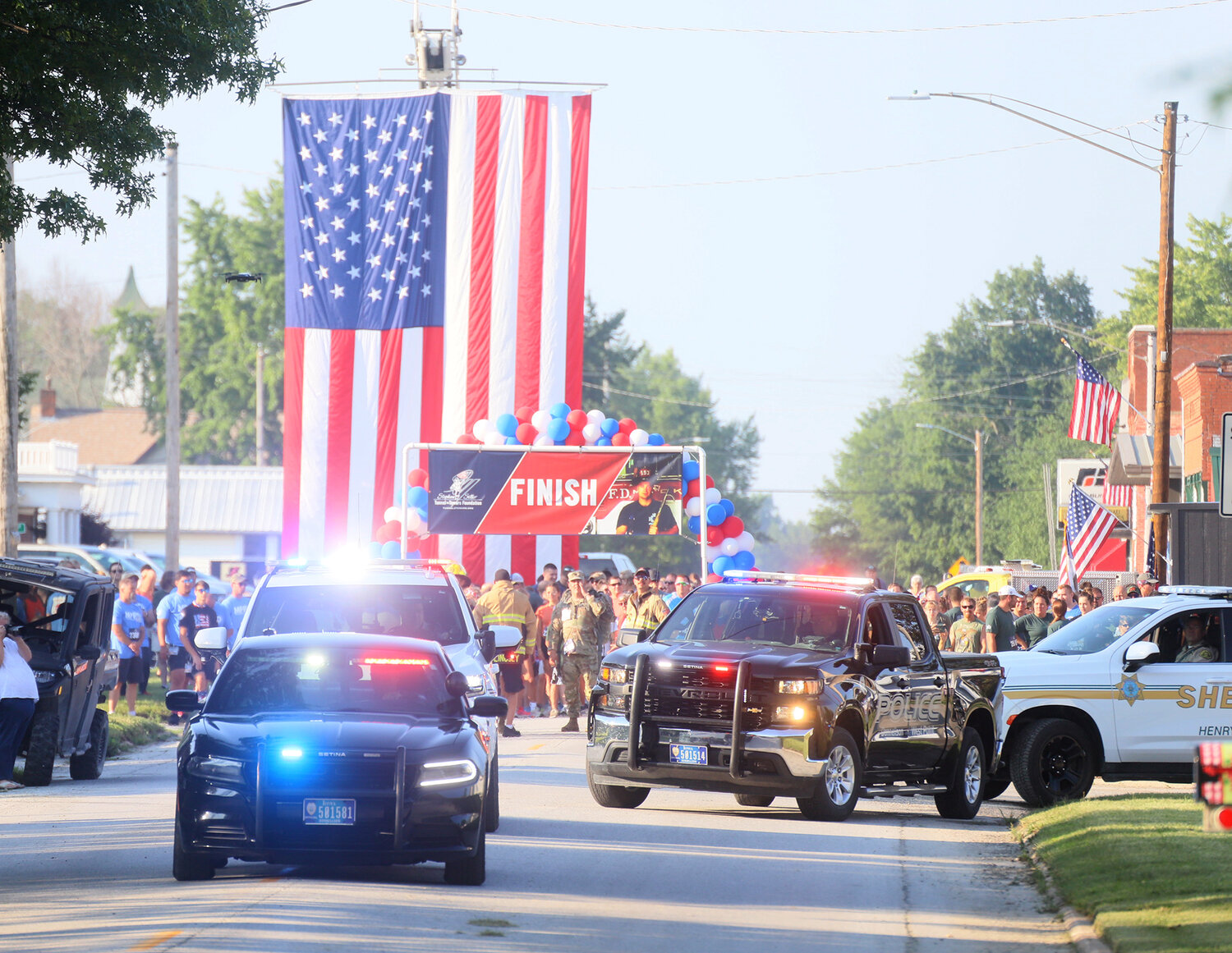Emergency responders file out to the 5K run route in Donnellson Tuesday morning. The vehicles lined the run route on North Main Street.
