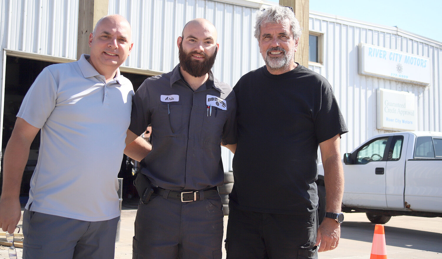 From left to right: Mark Cox, Aris Cox, and Chris Greenwald have entered into a five-year partnership at River City Motors Plus. After five years, the Cox family will take ownership of the business. In the meantime, they are adding a body shop service to the dealership.